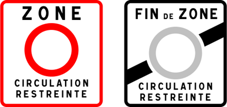 Two road signs one with a red circle and the other with a gray circle and diagonal line.