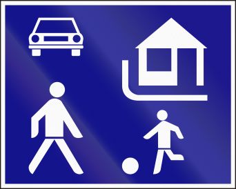 Blue traffic sign with white icons of a car, a house, an adult and child playing with a ball.