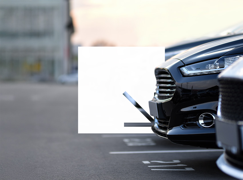 Row of parked rental cars ready for collection, highlighting the value of car hire excess insurance when picking up a vehicle.