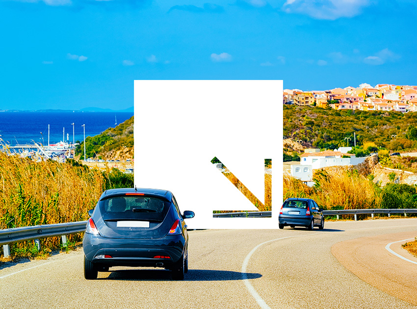 Cars driving along a coastal road in Italy, showing why travellers often rely on car hire excess insurance for protection abroad.